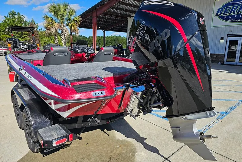 Slide: The Image of 2026 Phoenix 819 ZXL boat with powerful outboard motor, parked outdoors. - 9