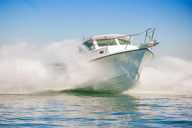 Slide: The Image of 2026 Parker 257 Explorer boat cruising swiftly on open water. - 13