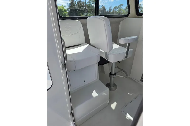 Slide: The Image of Interior of 2026 Parker 257 Explorer boat with white seating and windows. - 15