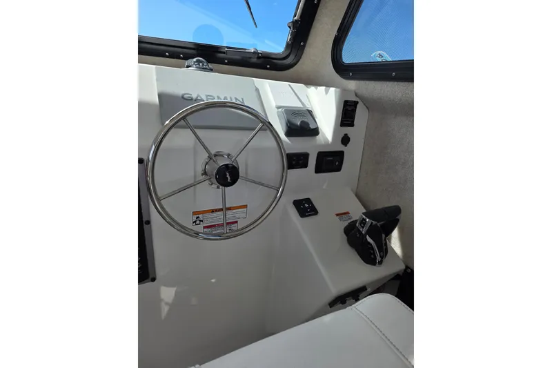 Slide: The Image of Interior helm of 2026 Parker 257 Explorer boat with Garmin navigation system. - 17