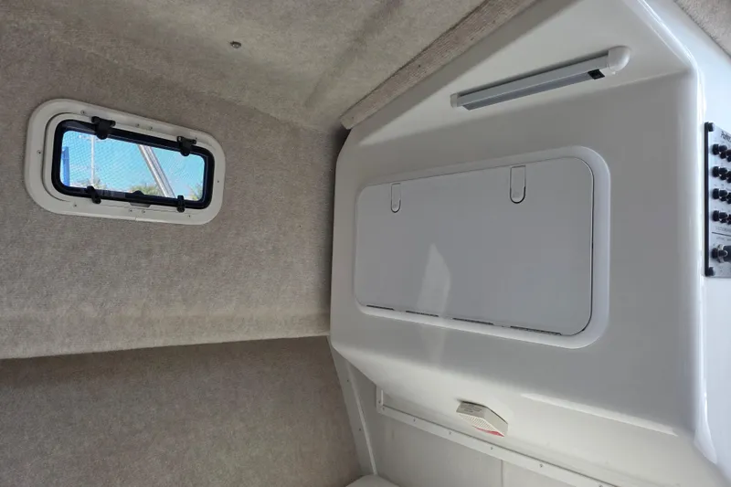 Slide: The Image of Interior cabin of 2026 Parker 257 Explorer boat with window and storage compartment. - 21