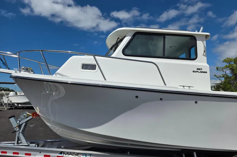 Slide: The Image of 2026 Parker 257 Explorer boat on trailer under blue sky. - 27