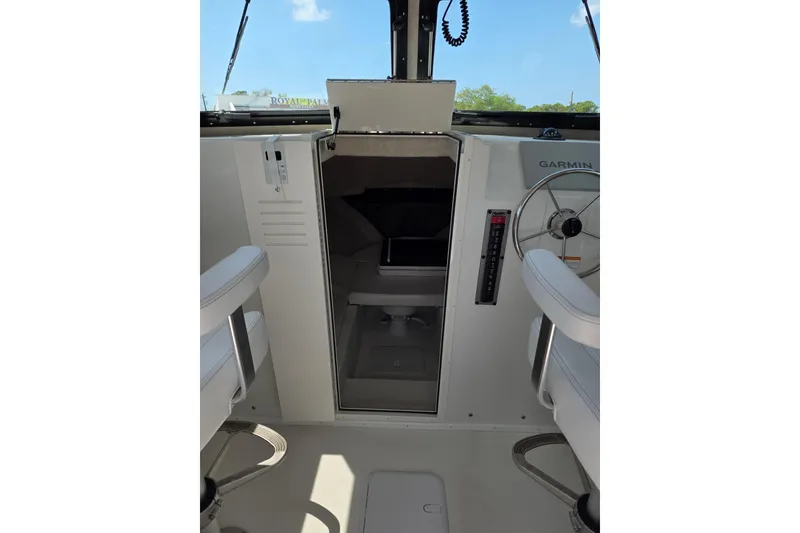 Slide: The Image of Interior view of 2026 Parker 257 Explorer boat cockpit with steering wheel and seating. - 28