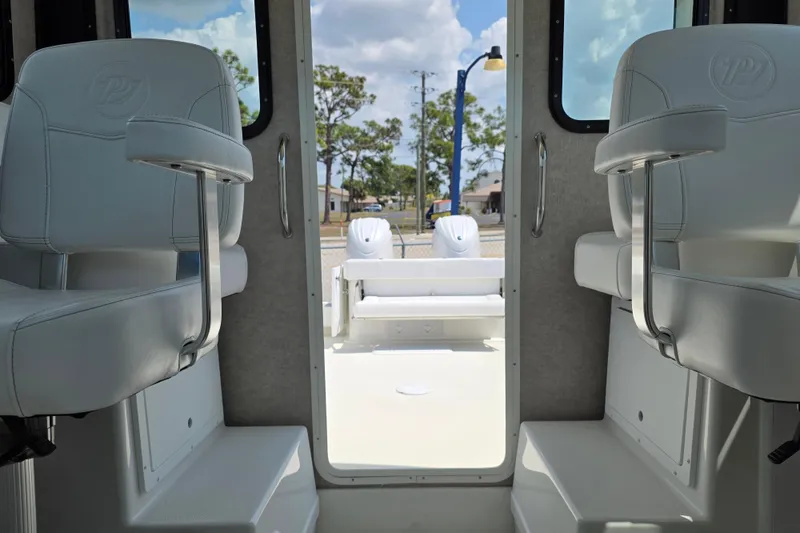 Slide: The Image of 2026 Parker 257 Explorer boat interior with white seating and open deck view. - 31