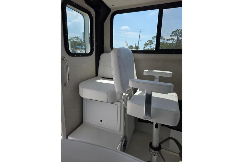 Slide: The Image of Interior of 2026 Parker 257 Explorer boat with white seating and large windows. - 32