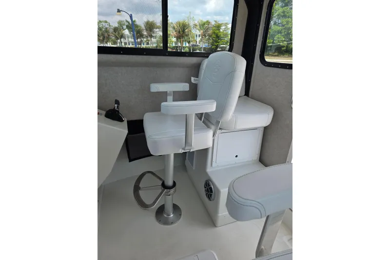 Slide: The Image of Captain's chair inside 2026 Parker 257 Explorer boat, featuring sleek white upholstery. - 33
