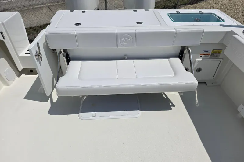 Slide: The Image of 2026 Parker 257 Explorer boat with foldable white bench seat and storage compartments. - 34