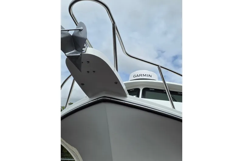 Slide: The Image of 2026 Parker 257 Explorer boat with Garmin equipment, viewed from below against cloudy sky. - 36