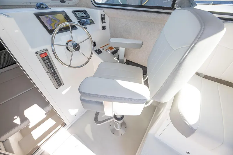 Slide: The Image of Manufacturer Provided Image: 2026 Parker 257 Explorer boat helm with steering wheel and navigation controls. - 4