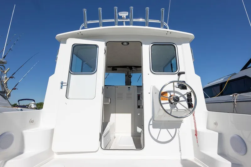 Slide: The Image of 2026 Parker 257 Explorer boat on trailer under a partly cloudy sky. - 6