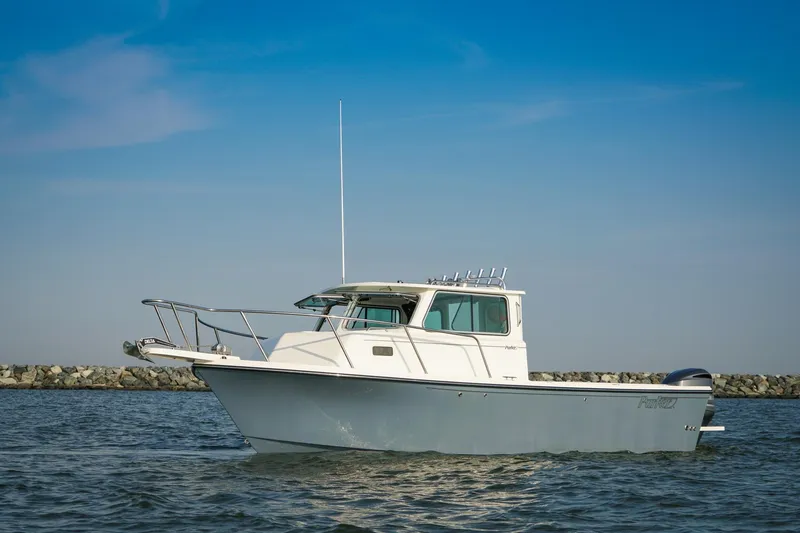 Slide: The Image of 2026 Parker 257 Explorer boat on calm water under clear blue sky. - 9