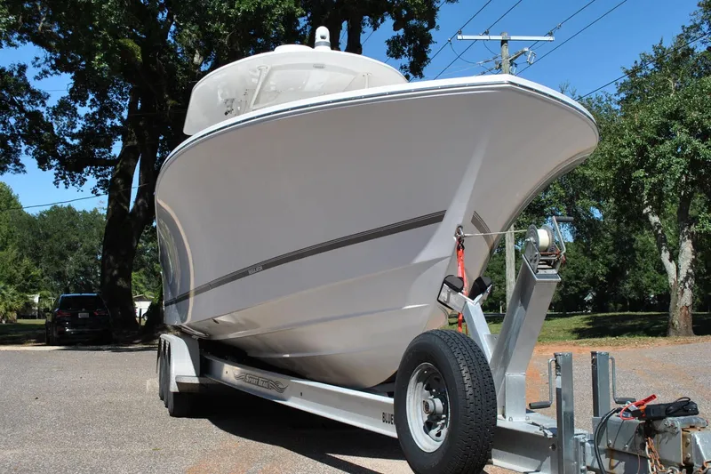 Slide: The Image of 2016 Regulator 34 Center Console boat on trailer, parked outdoors. - 10
