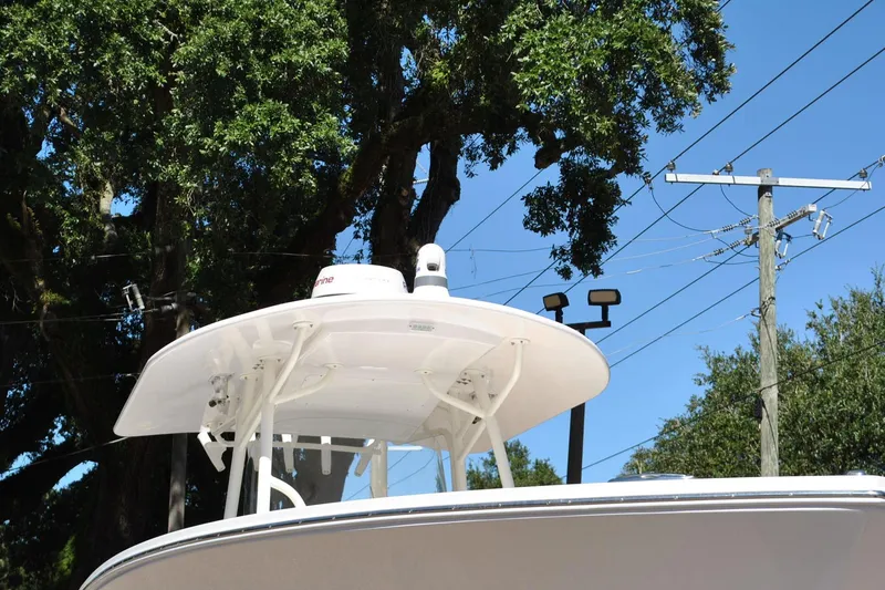 Slide: The Image of 2016 Regulator 34 Center Console boat with radar, under clear blue sky. - 11