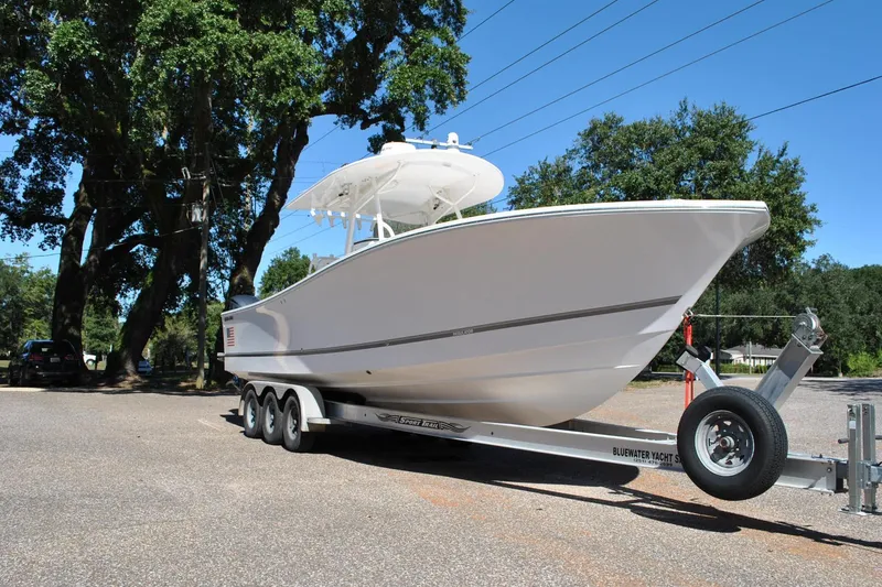Slide: The Image of 2016 Regulator 34 Center Console boat on trailer, parked outdoors. - 13