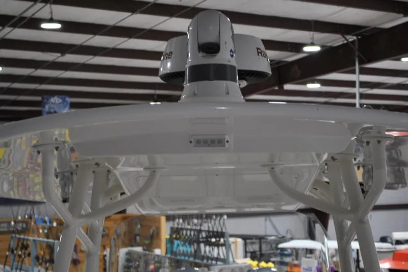 Slide: The Image of 2016 Regulator 34 Center Console boat with radar equipment in a showroom. - 16