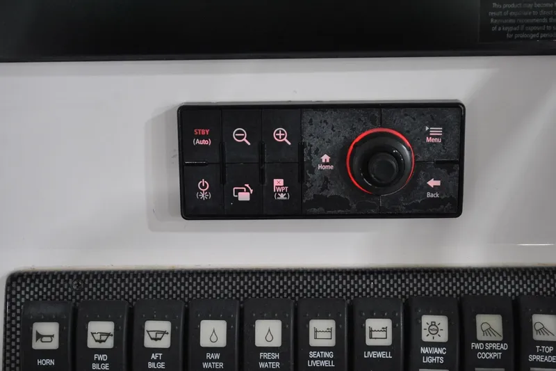 Slide: The Image of Control panel of a 2016 Regulator 34 Center Console boat with various function buttons. - 29