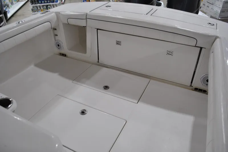 Slide: The Image of 2016 Regulator 34 Center Console boat interior with storage compartments and seating. - 35