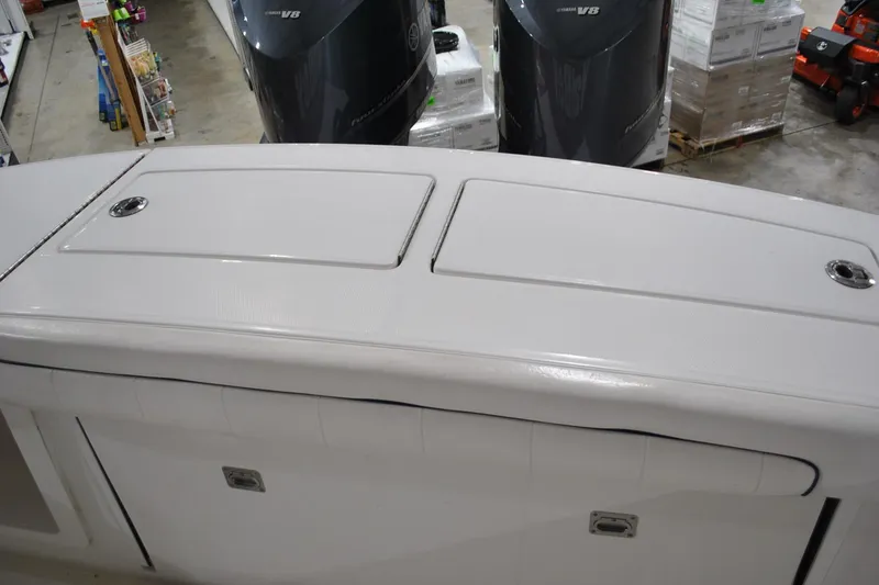 Slide: The Image of 2016 Regulator 34 Center Console boat with dual Yamaha V8 engines in a showroom. - 36