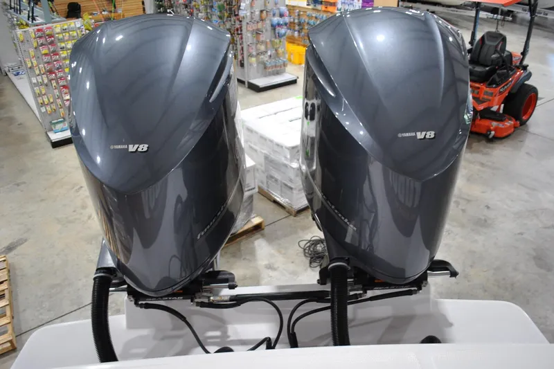 Slide: The Image of Twin Yamaha V8 engines on a 2016 Regulator 34 Center Console boat in a showroom. - 37