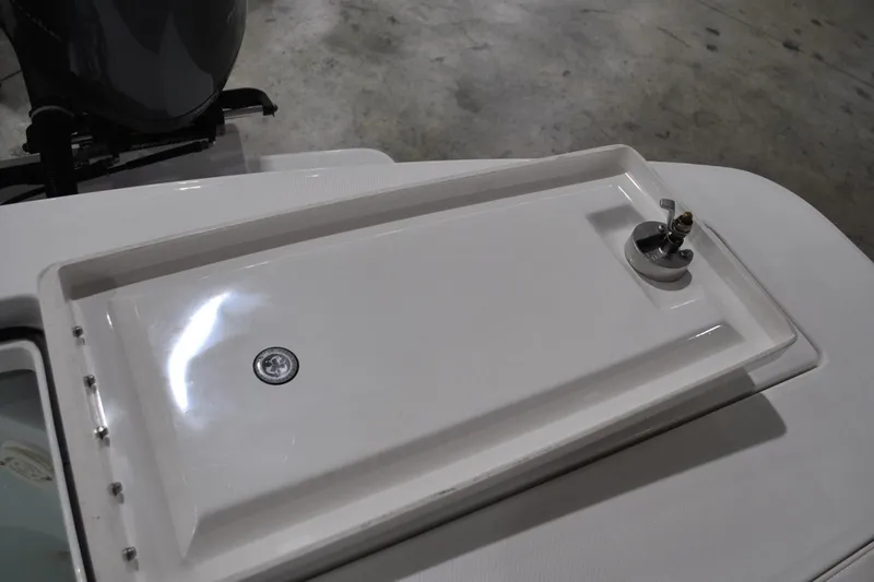 Slide: The Image of 2016 Regulator 34 Center Console boat deck with storage compartment and latch. - 40