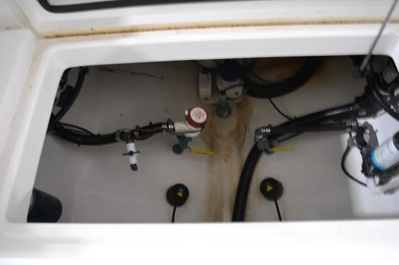 Slide: The Image of 2016 Regulator 34 Center Console boat interior with visible plumbing and wiring components. - 43