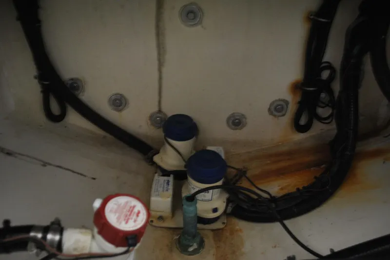Slide: The Image of Bilge area of 2016 Regulator 34 Center Console with pumps and wiring. - 49
