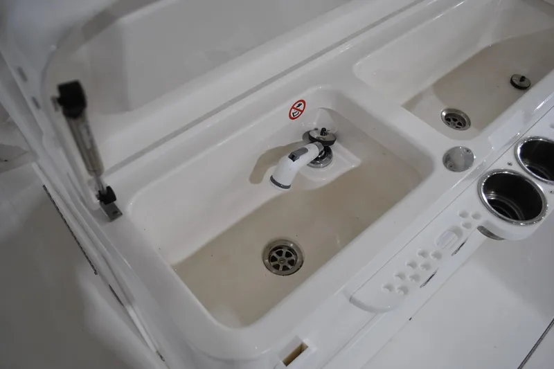 Slide: The Image of 2016 Regulator 34 Center Console sink and cup holders on deck. - 53