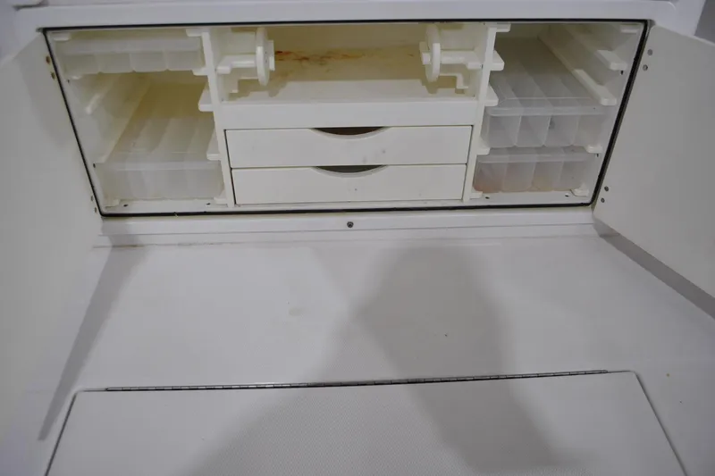 Slide: The Image of 2016 Regulator 34 Center Console storage compartment with drawers and tackle boxes. - 55