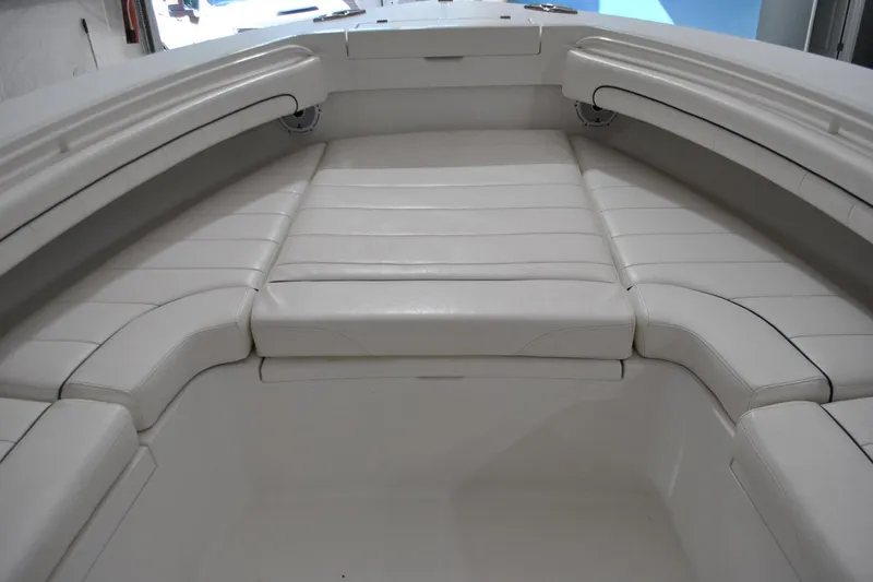 Slide: The Image of 2016 Regulator 34 Center Console boat with white cushioned seating area. - 59