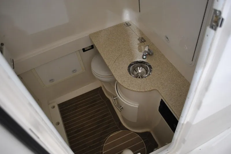 Slide: The Image of 2016 Regulator 34 Center Console boat bathroom with sink and toilet. - 62