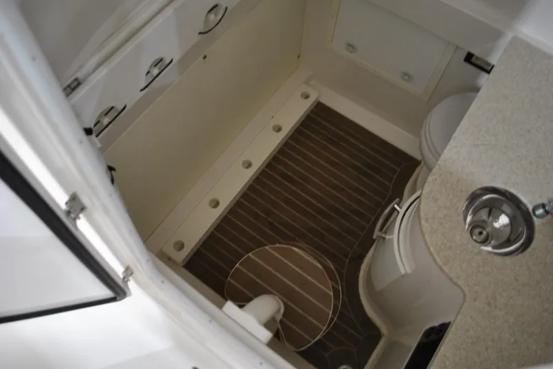 Slide: The Image of Interior view of a 2016 Regulator 34 Center Console boat cabin with wood flooring. - 63