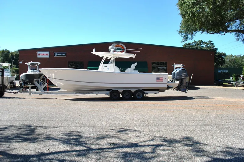 Slide: The Image of 2016 Regulator 34 Center Console boat on trailer outside dealership. - 7