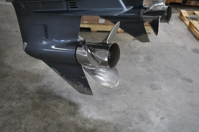 Slide: The Image of Twin propellers of a 2016 Regulator 34 Center Console on a concrete floor. - 75