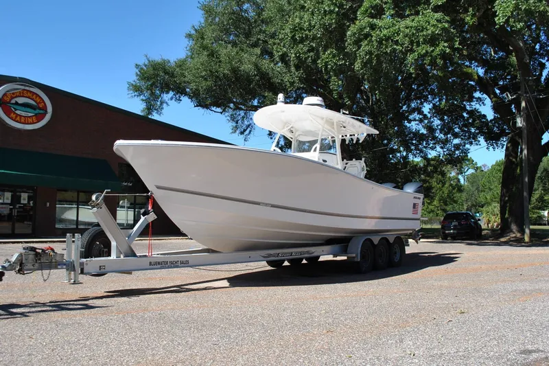 Slide: The Image of 2016 Regulator 34 Center Console boat on trailer outside Sportsman's Marine. - 8