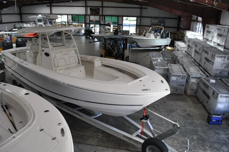 Slide: The Image of 2016 Regulator 34 Center Console boat in warehouse, surrounded by Yamaha equipment. - 80