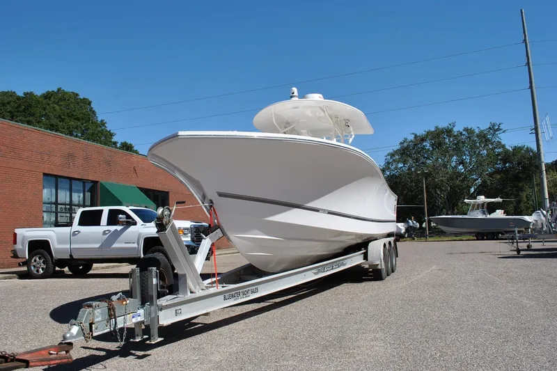 Slide: The Image of 2016 Regulator 34 Center Console boat on trailer, parked outdoors. - 82