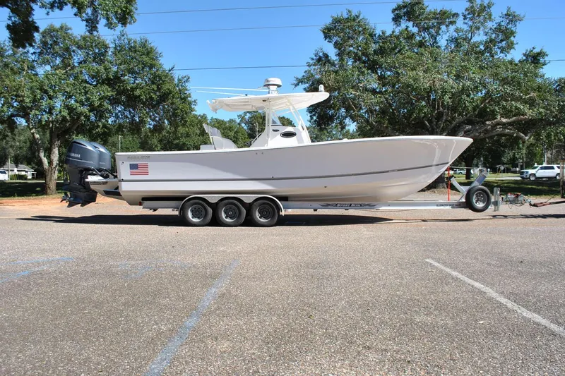Slide: The Image of 2016 Regulator 34 Center Console boat on trailer in parking lot. - 83
