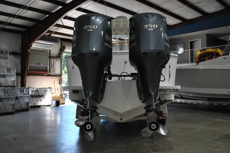 Slide: The Image of 2016 Regulator 34 Center Console with twin Yamaha 350 V8 engines in a warehouse. - 84