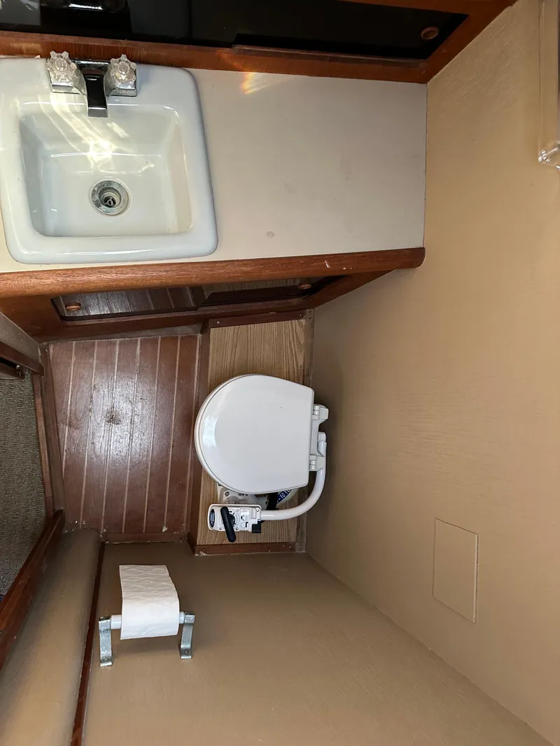 Slide: The Image of 1987 Bayliner 3888 Motoryacht bathroom with sink and toilet. - 17