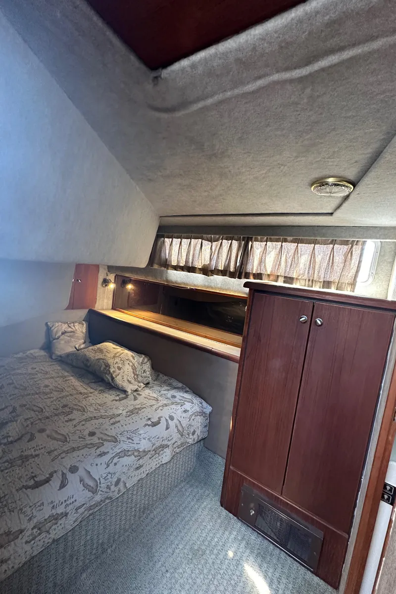 Slide: The Image of Interior cabin of 1987 Bayliner 3888 Motoryacht with bed and wooden cabinet. - 23