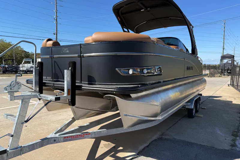 Slide: The Image of 2026 Avalon Catalina Quad Lounger Windshield pontoon boat on trailer, outdoor display. - 10
