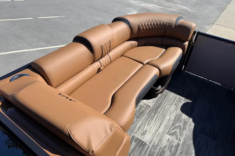 Slide: The Image of Luxurious seating on 2026 Avalon Catalina Quad Lounger Windshield boat, featuring tan leather upholstery. - 26