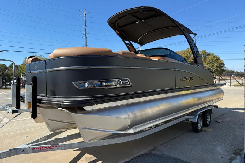 Slide: The Image of 2026 Avalon Catalina Quad Lounger Windshield pontoon boat on trailer, sleek design, outdoor setting. - 3