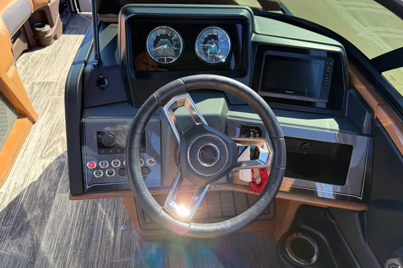 Slide: The Image of Steering console of 2026 Avalon Catalina Quad Lounger Windshield with modern controls and gauges. - 34