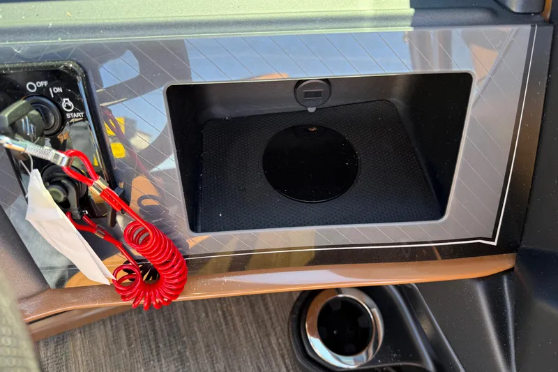 Slide: The Image of 2026 Avalon Catalina Quad Lounger Windshield dashboard with ignition switch and storage compartment. - 37