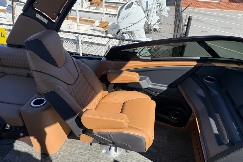 Slide: The Image of Luxurious seating in 2026 Avalon Catalina Quad Lounger Windshield boat, featuring tan upholstery and cup holders. - 42