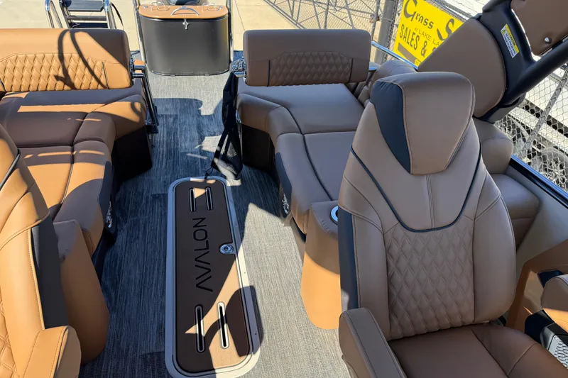Slide: The Image of Luxurious interior of 2026 Avalon Catalina Quad Lounger Windshield boat with tan seating. - 45