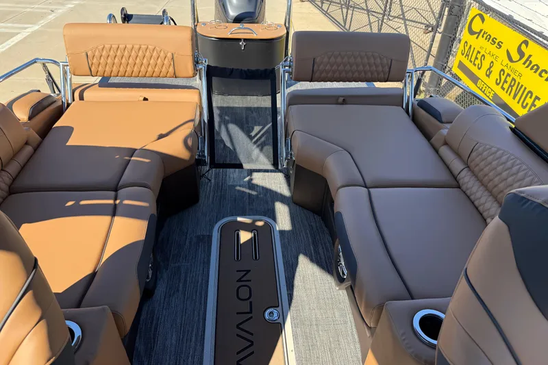 Slide: The Image of 2026 Avalon Catalina Quad Lounger Windshield boat interior with luxurious tan seating. - 48