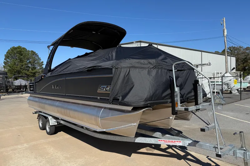 Slide: The Image of 2026 Avalon Catalina Quad Lounger Windshield pontoon boat on trailer, covered and parked outdoors. - 5