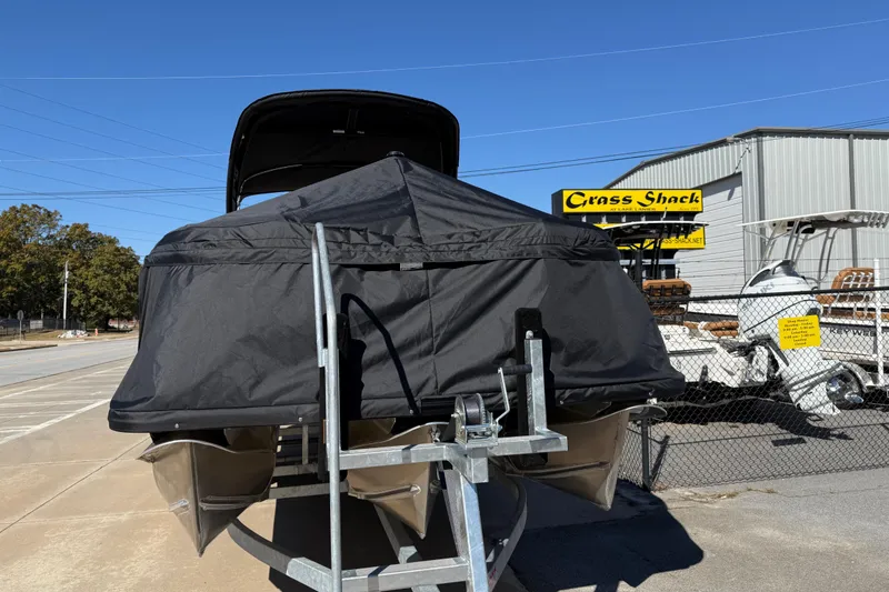 Slide: The Image of 2026 Avalon Catalina Quad Lounger Windshield boat covered, parked at dealership. - 6